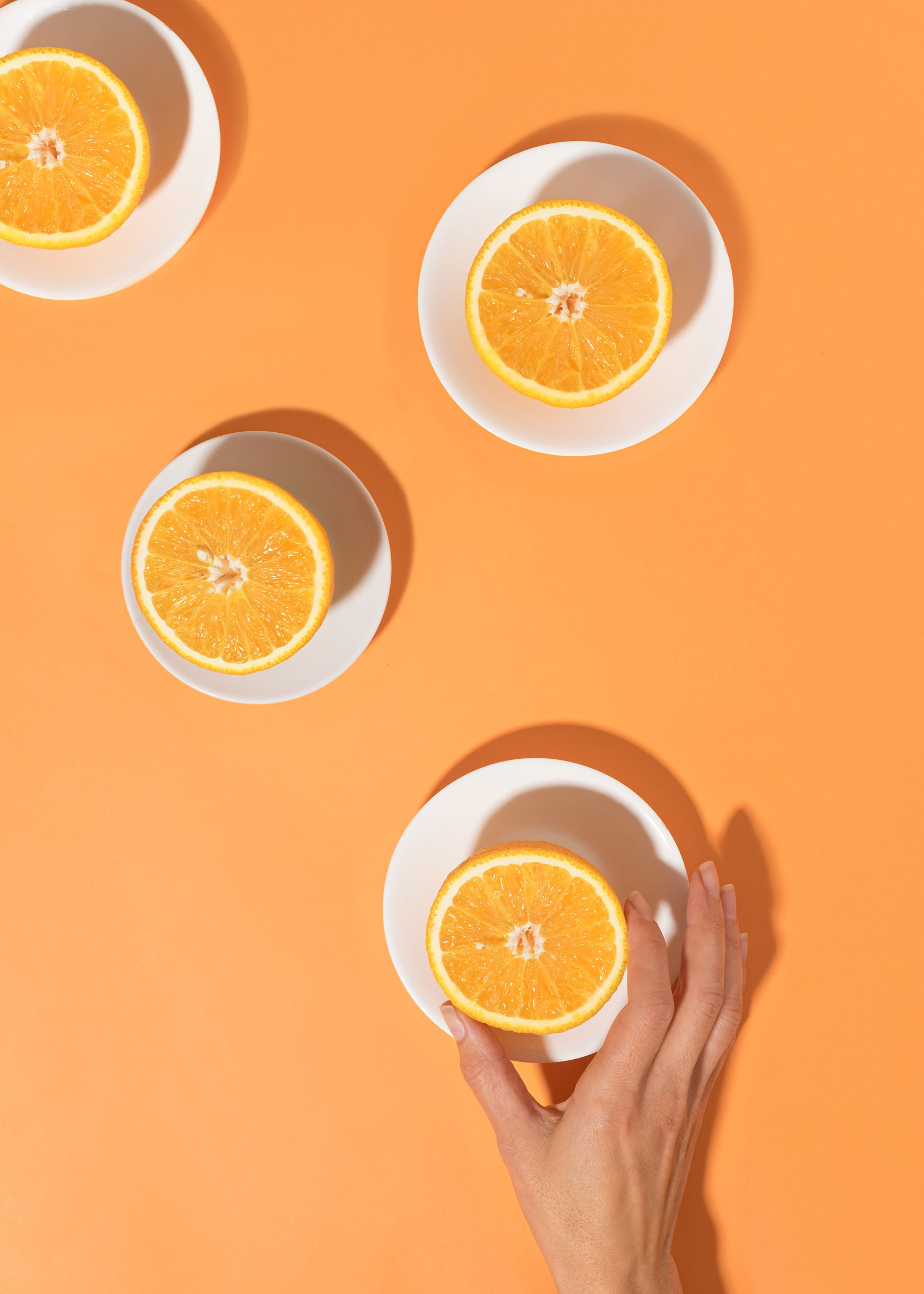 oranges-on-in-plates-on-a-bright-table-and-a-woman-2021-09-04-15-57-44-utc.jpg